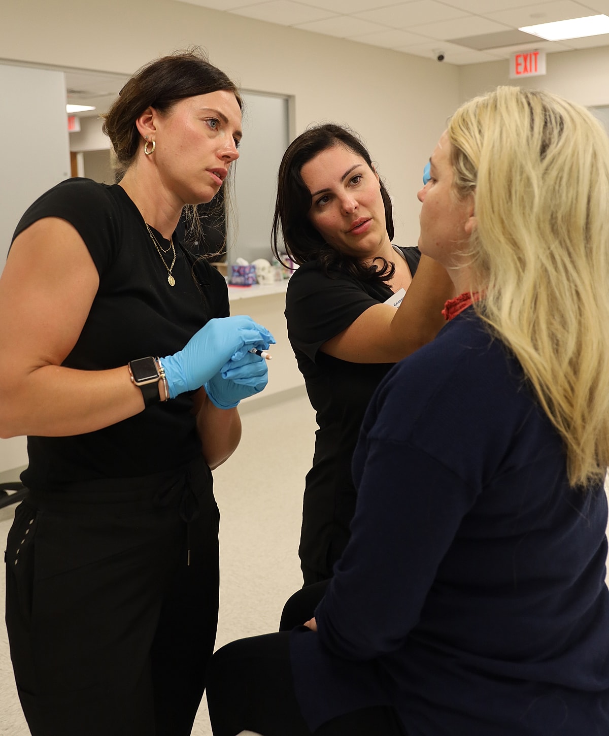 Medical professionals consulting during a cosmetic procedure.