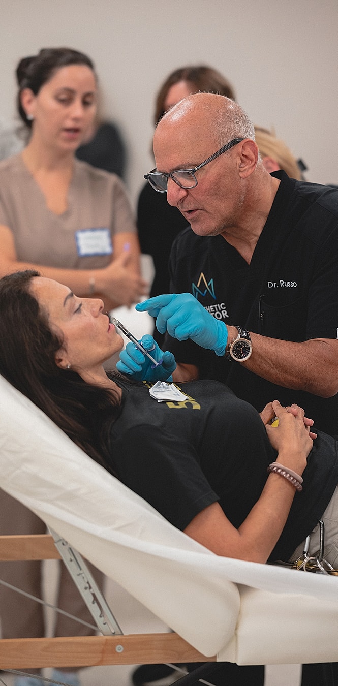 Doctor performing cosmetic procedure on patient.