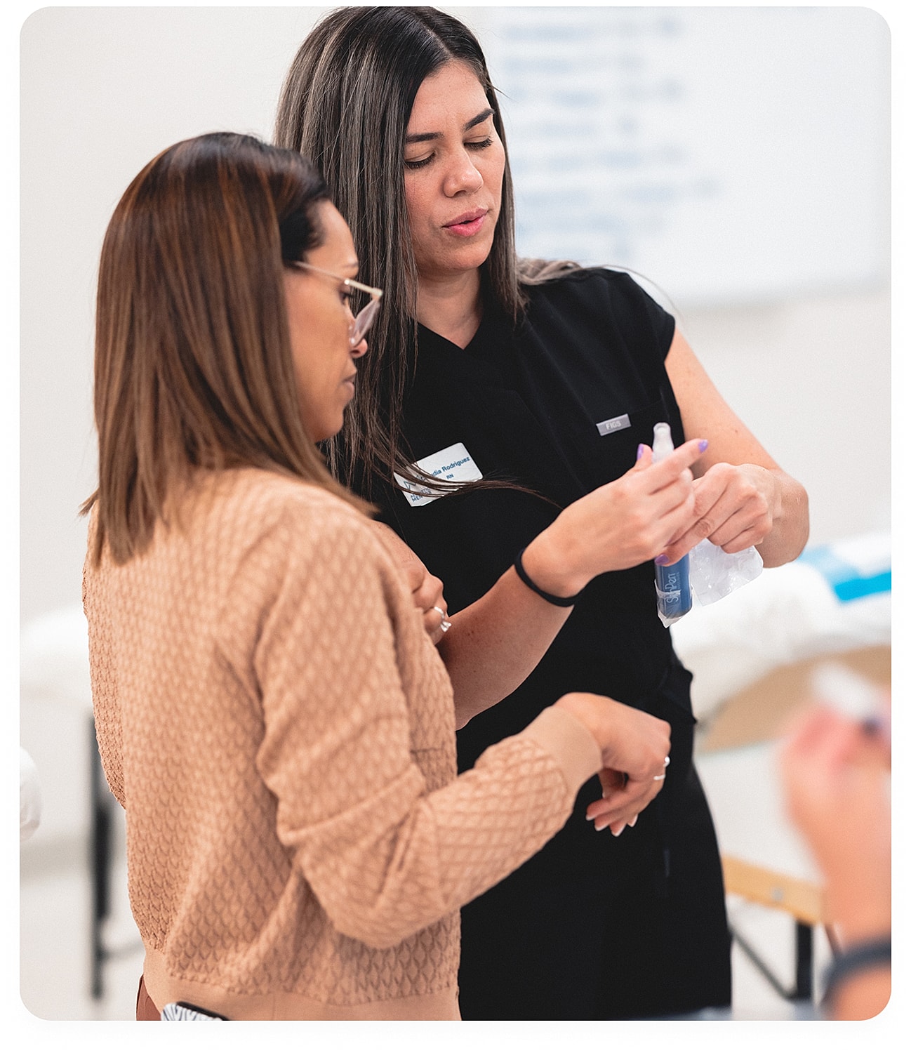 Two women discussing a skin treatment procedure.