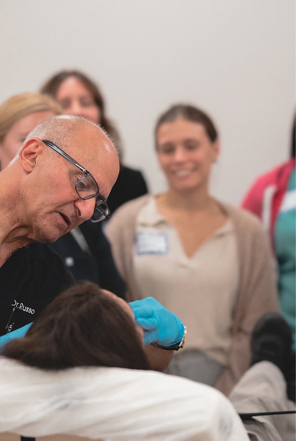 Medical professional demonstrating a procedure on student.