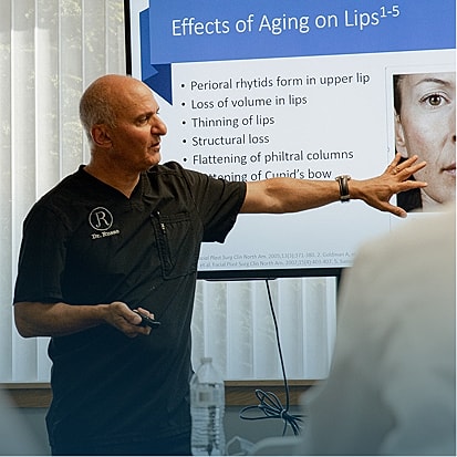 Speaker presenting on aging effects on lips