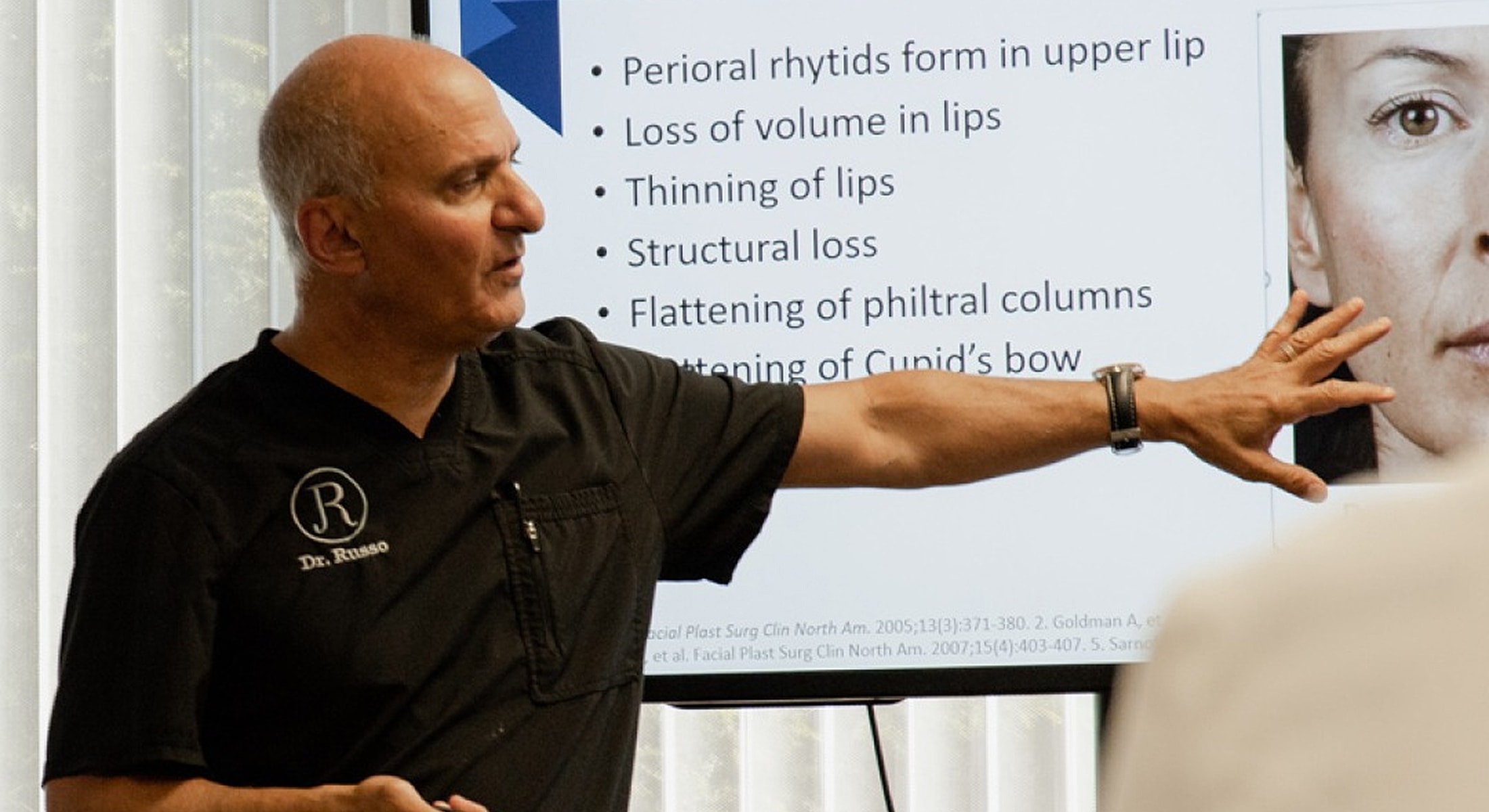 Doctor presenting on lip aesthetics and structures.