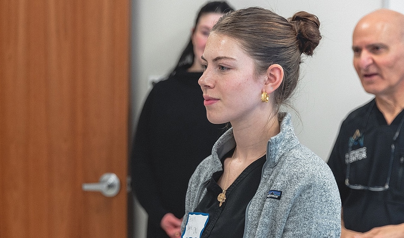Person listening intently in a group setting.