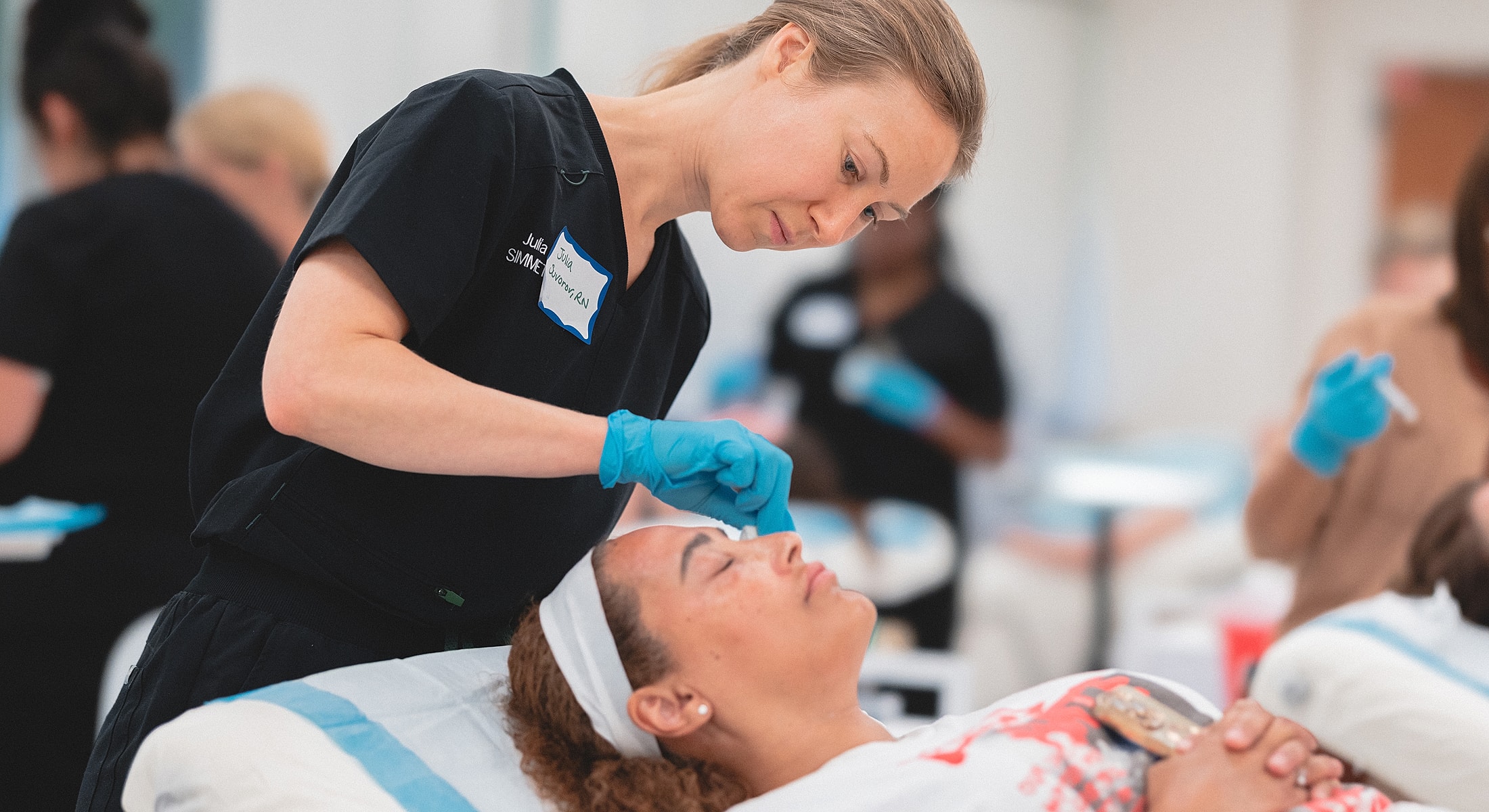 Medical professional administering treatment to patient.