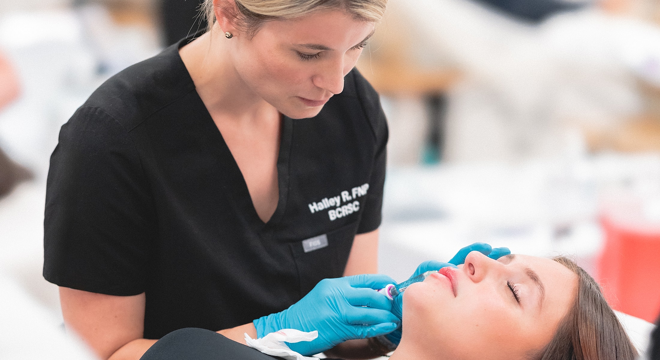 Professional administering a treatment to a client.