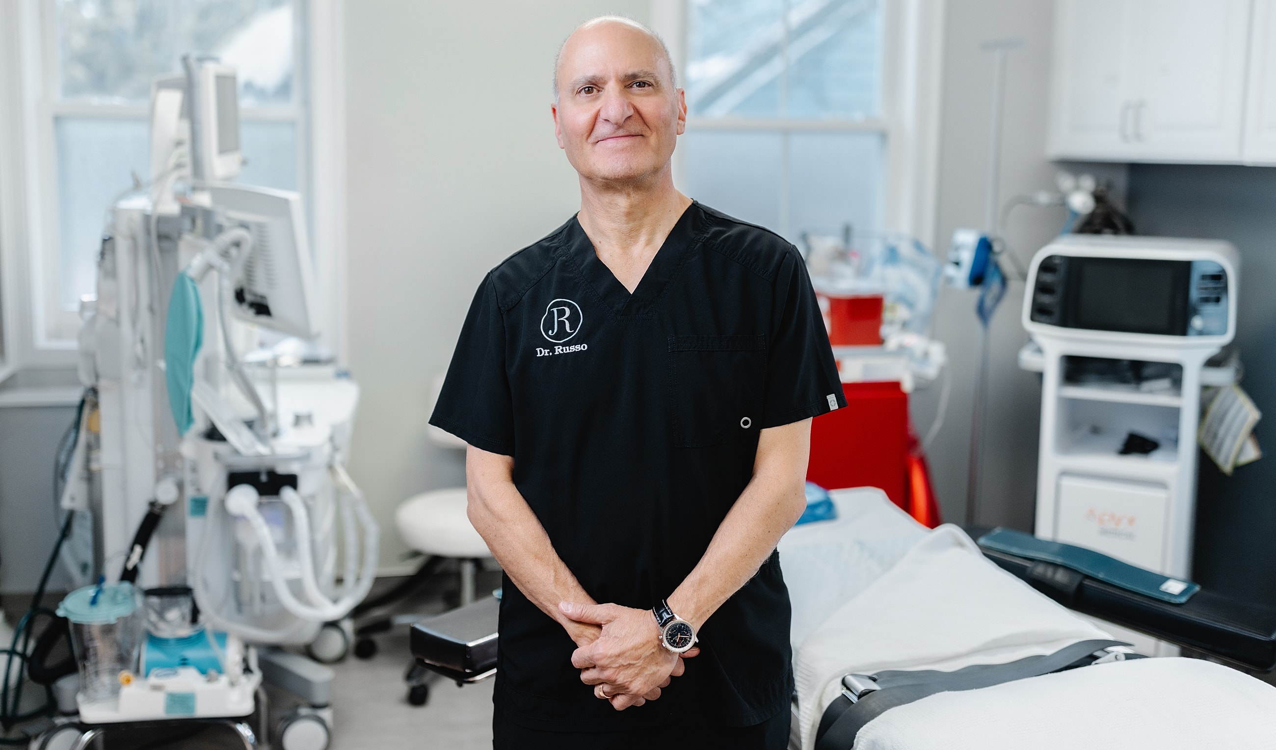 Doctor standing in a medical office setting.
